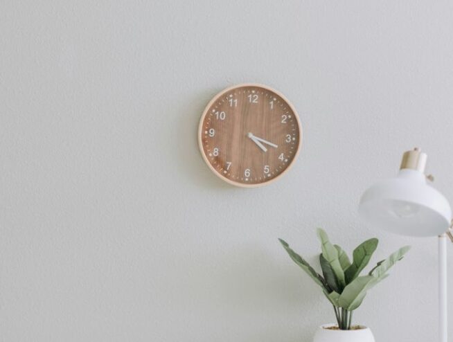 white desk lamp beside green plant