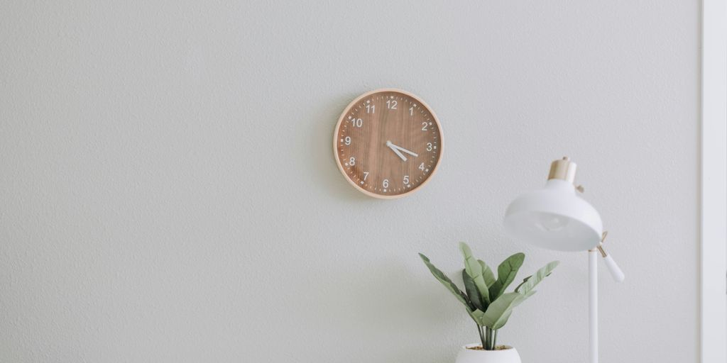 white desk lamp beside green plant